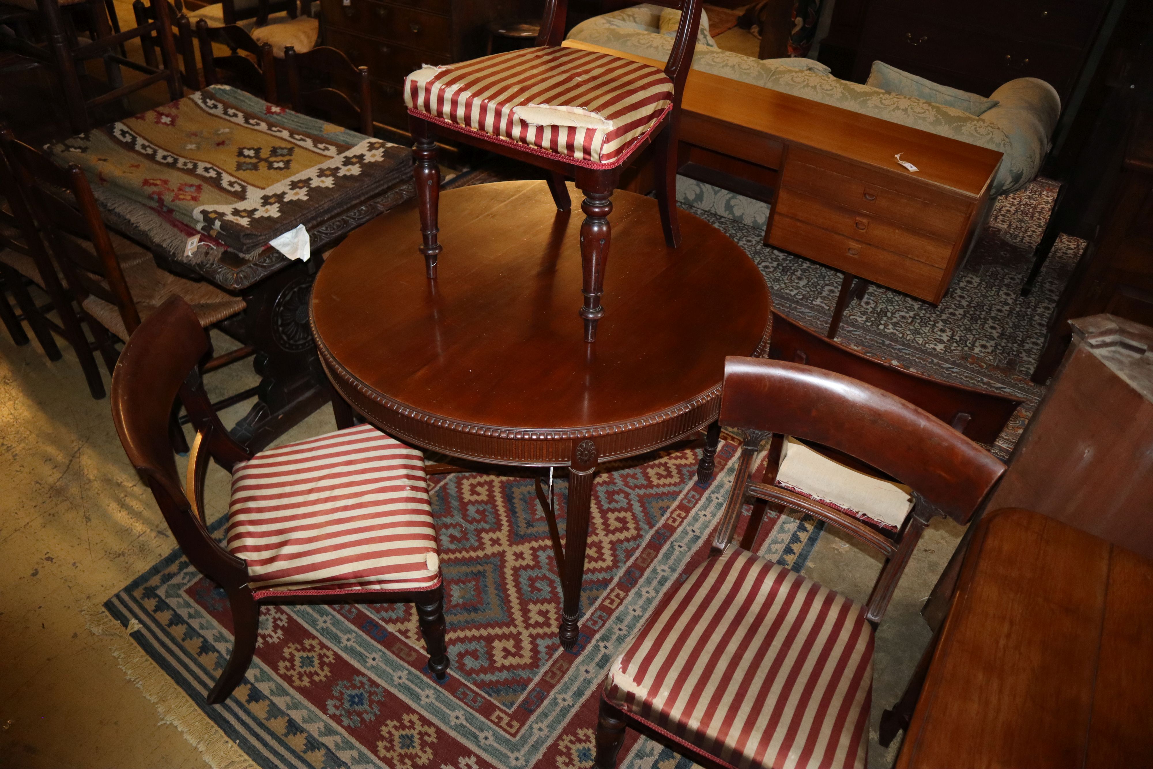 An early 20th century mahogany centre table, 105cm diameter together with four early Victorian mahogany dining chairs and one other din